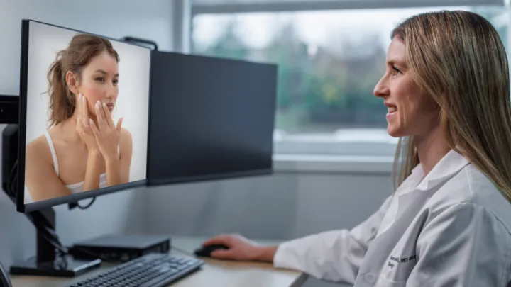 Dermatologist consulting with patient over video
