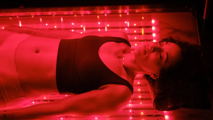 Woman in red light therapy bed