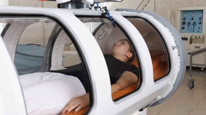Woman lying in a hyperbaric chamber