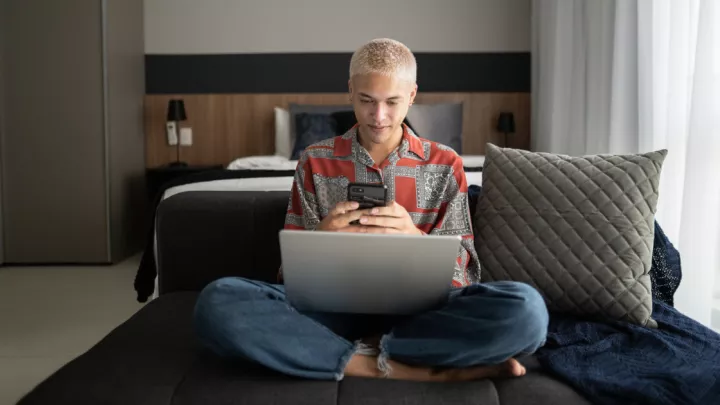 Man sitting on the couch looking at his phone