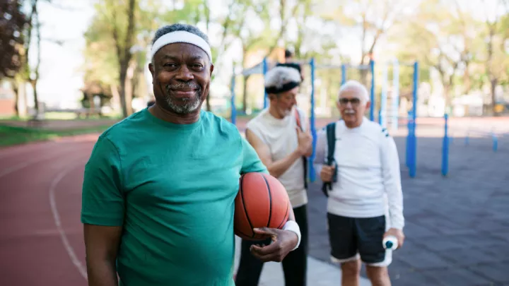 Older man holding a basketball