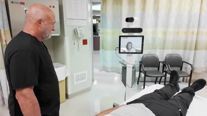 Steve Lapke, MD and patient Roger Vial speaking with Kelly-Ann Patrice, MD on video