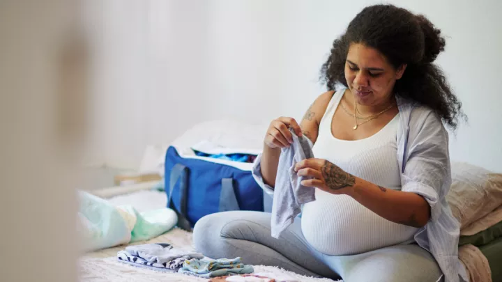 Pregnant woman packing a hospital bag