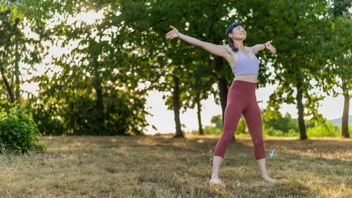 Woman doing yoga barefoot outside