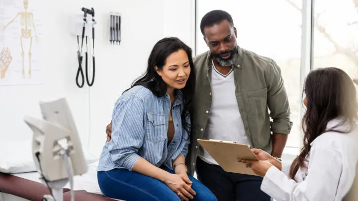 Man and woman talking to doctor