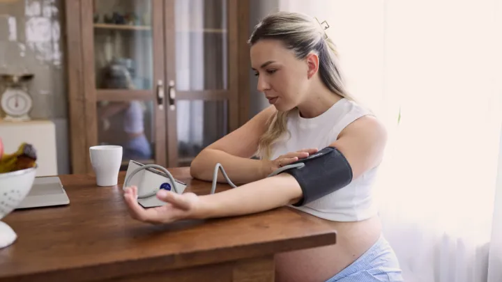 Pregnant woman taking her blood pressure