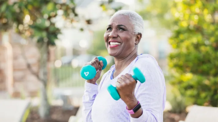Older woman holding hand weights