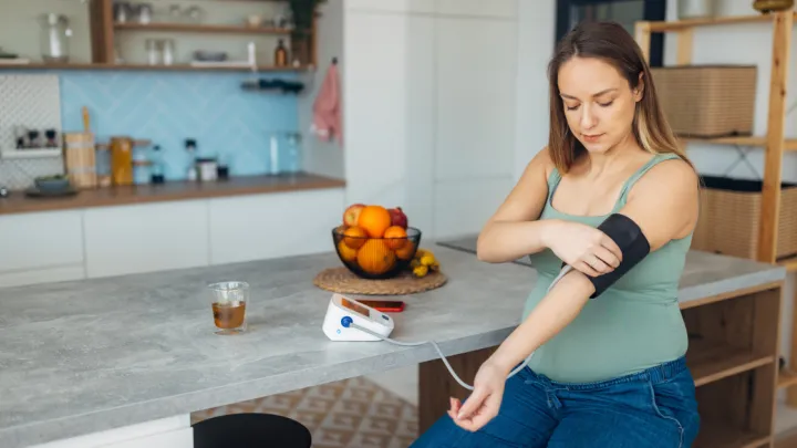 Pregnant woman checking her blood pressure