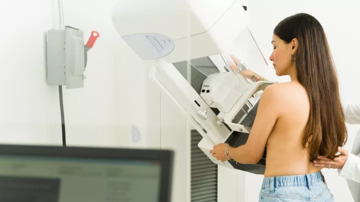 Doctor adjusting woman for a mammogram