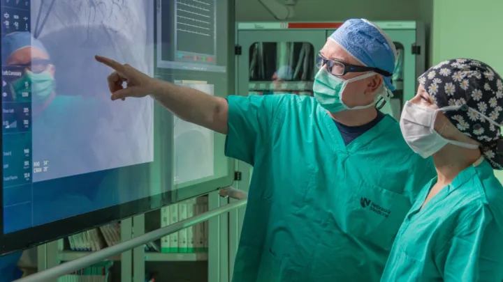 Doctor pointing to screen with heart imaging
