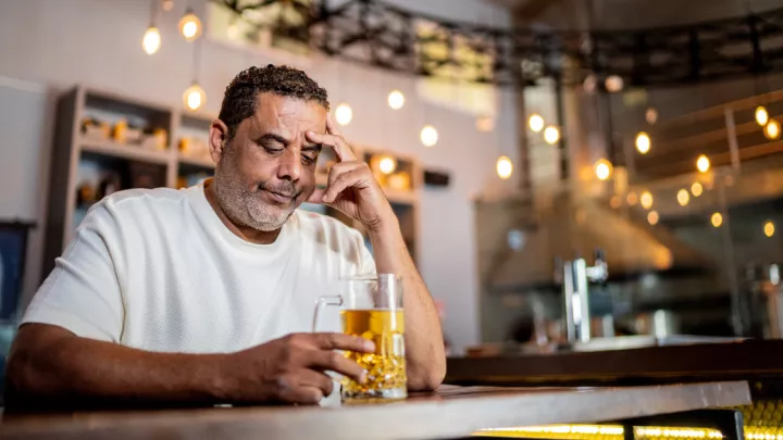 Man sitting at bar with beer