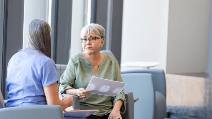 Doctor showing woman brain scans