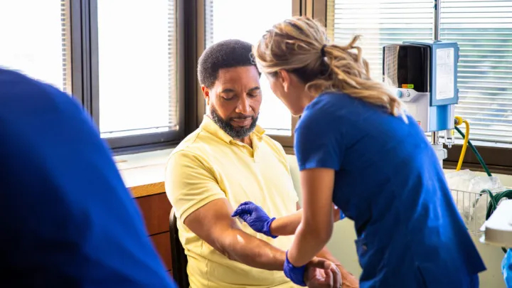 Man getting blood drawn by nurse