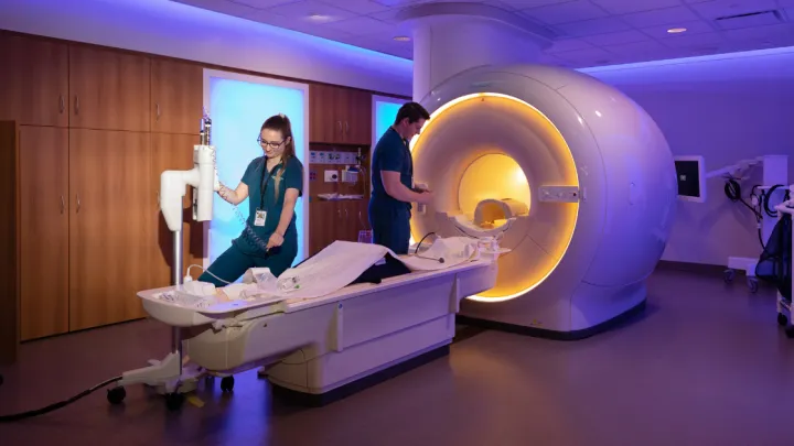 Two Nebraska Medicine providers preparing MRI machine