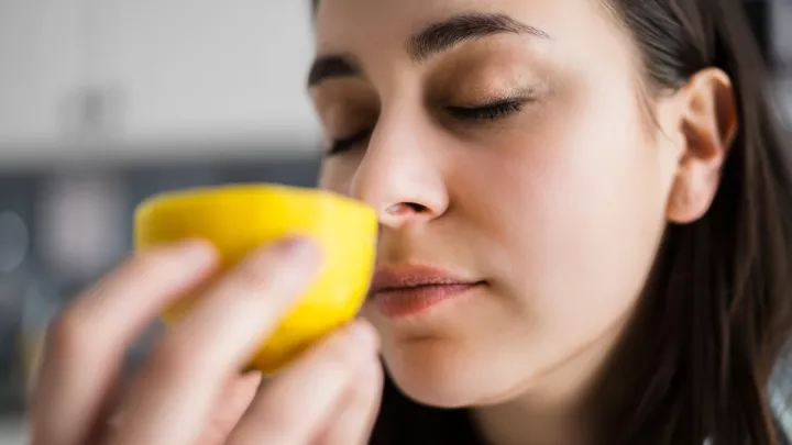Woman smelling lemon