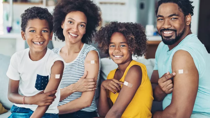 Family with vaccine bandages