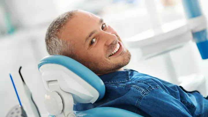 Man smiling in a dental chair