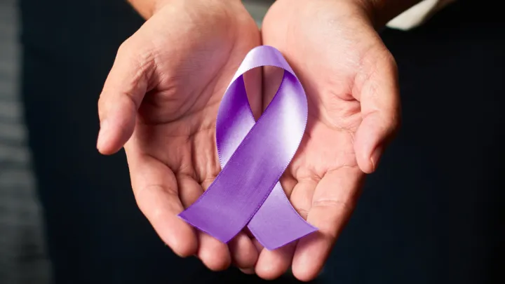 Woman holding purple ribbon