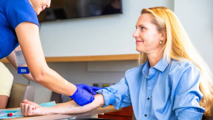 Woman getting her blood drawn by nurse