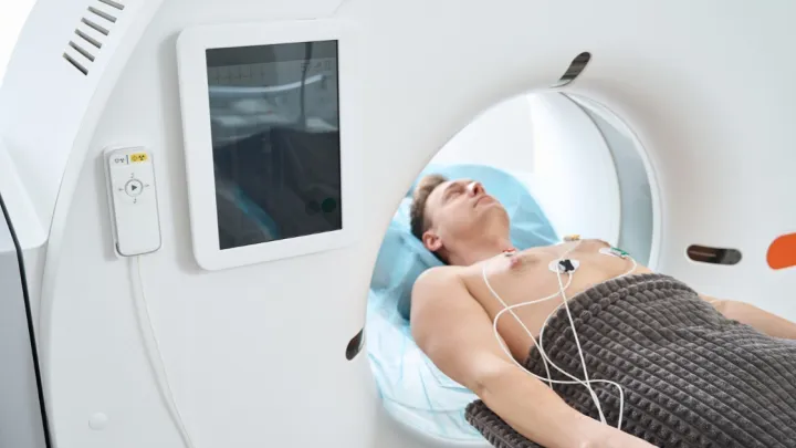 Man lying in CT machine