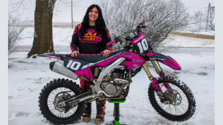 Raihanna Hartley standing with motorbike