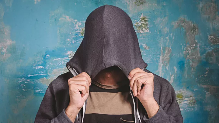 Man hiding his face in a hood