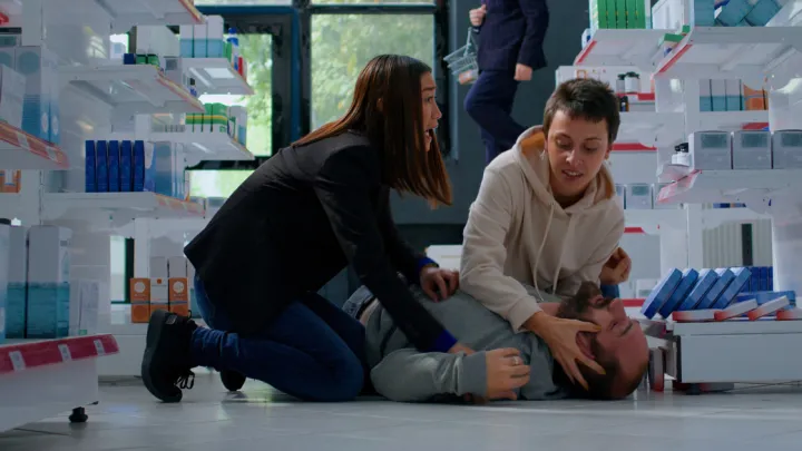 Two women helping man who had seizure