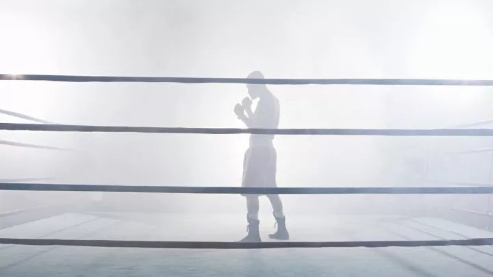Boxer standing in a foggy boxing ring