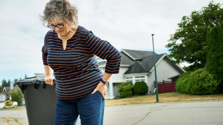 Woman holding her hip in pain