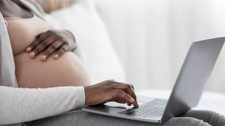 Pregnant woman on computer