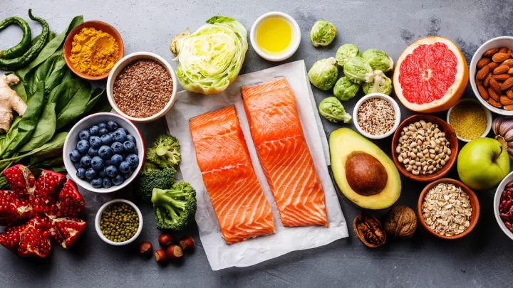 Salmon surrounded by fruits and vegetables