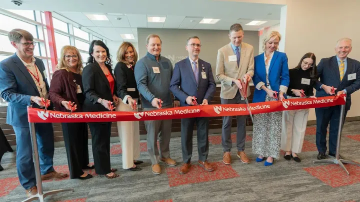 Nebraska Medicine leadership and physicians performing ribbon cutting at Bennington Health Center