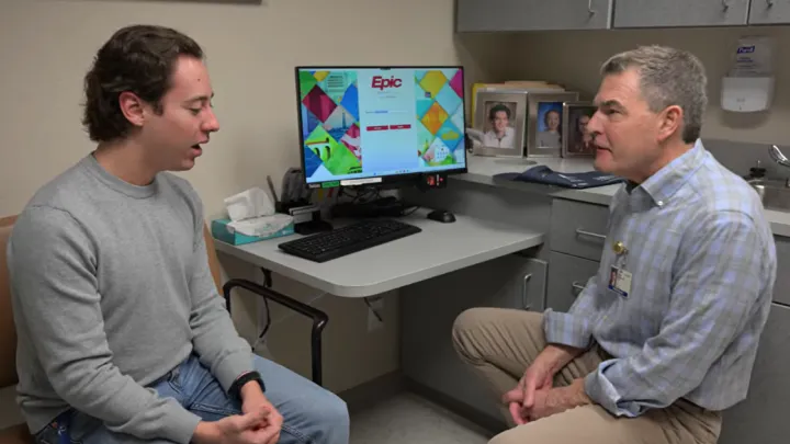 Patient Colin Gholson talking to Monument Health nephrologist, Louis Raymond, MD.