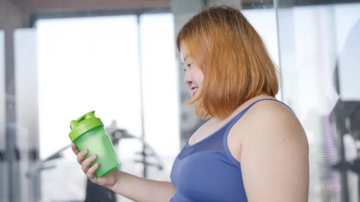 Woman holding protein shake