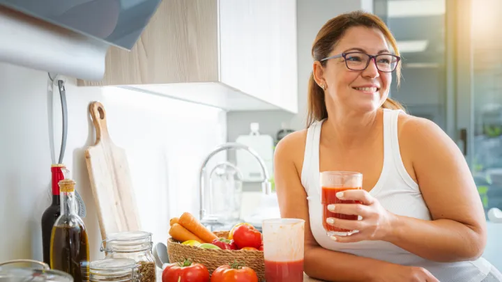 Woman holding glass of vegetable juice