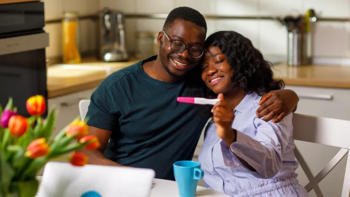 Happy couple looking at pregnancy test