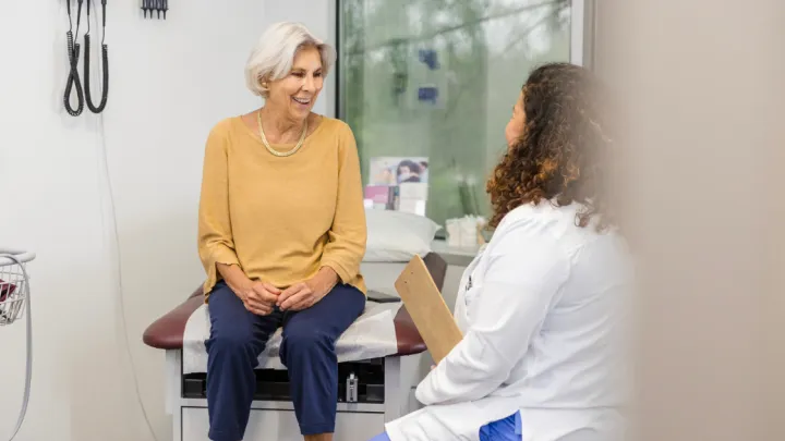 Older woman talking to doctor