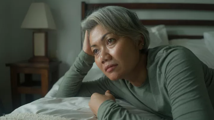 Woman lying awake in bed