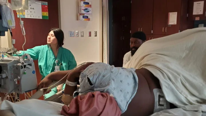 Patient Rhea Vinson, partner Roshaun Garrett, and nurse Lena Phan