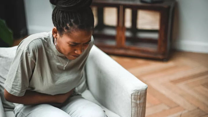 Woman holding her stomach in pain