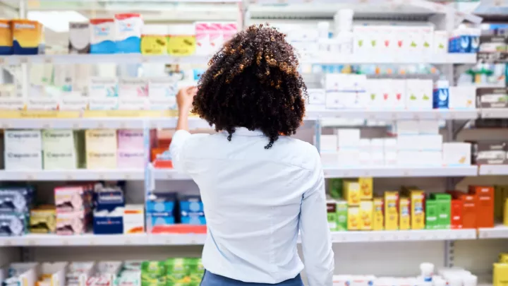 Woman shopping in pharmacy aisle