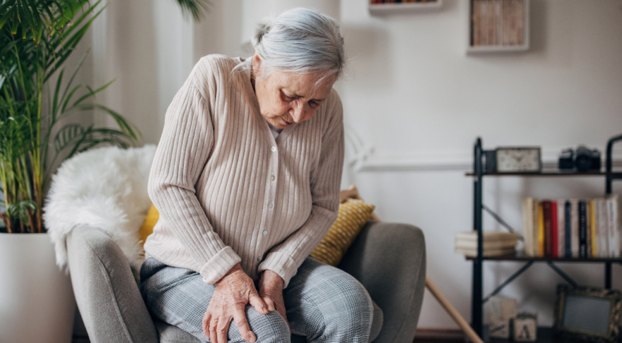 Woman holding her knee in pain