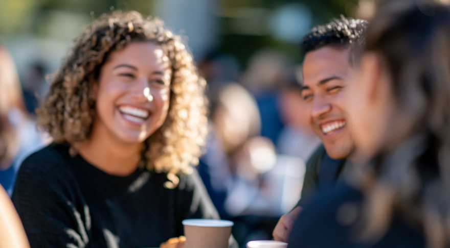 A group of people having coffee and pastries at a table