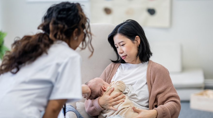 Lactation consultant talking to breastfeeding woman